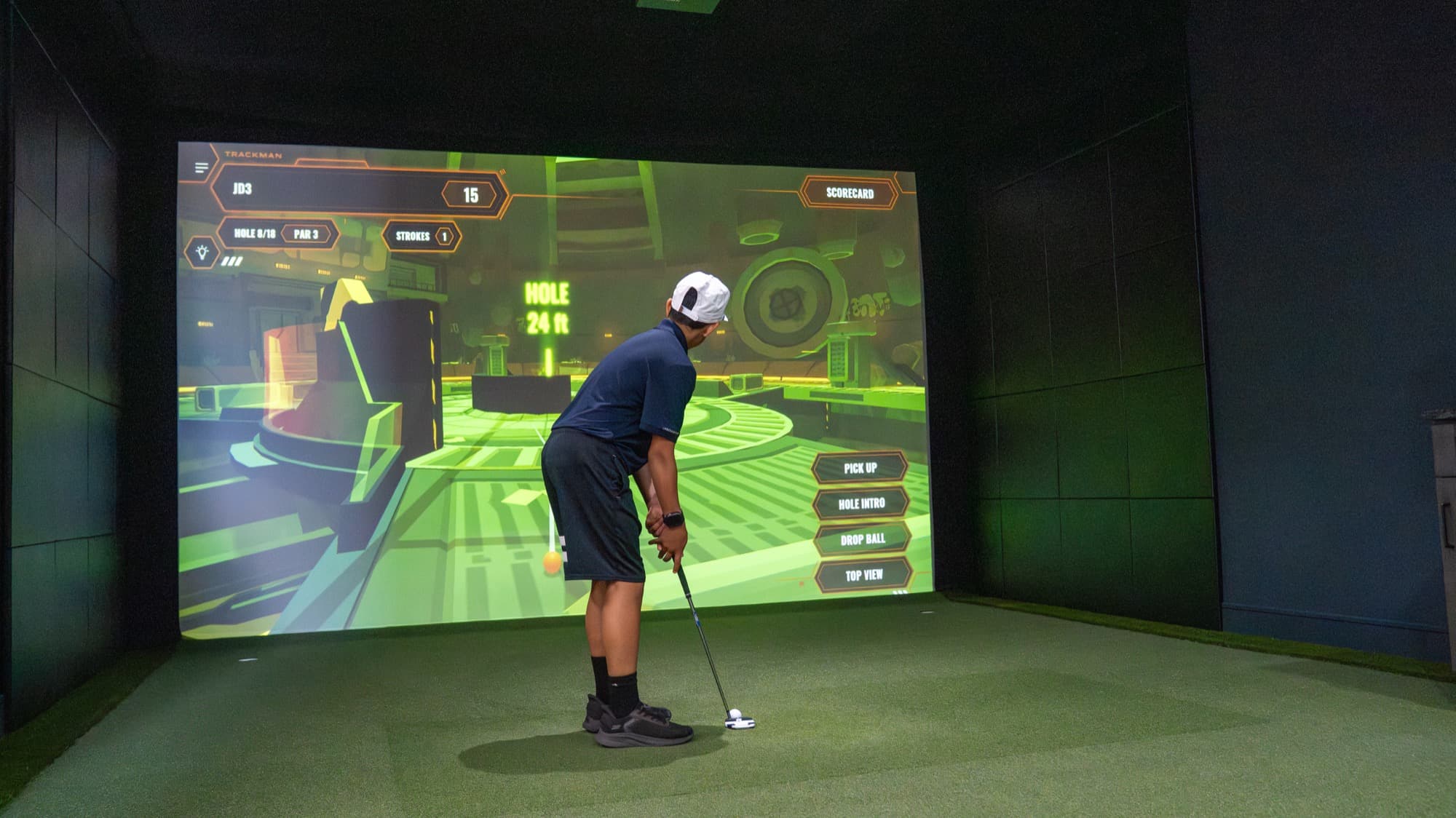 A child playing a kids’ game on a golf simulator at Unbound Golf